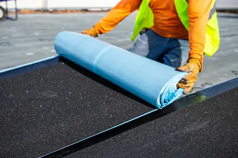 Roofing contractor installing synthetic underlayment during a roof replacement in Orangeburg County, SC